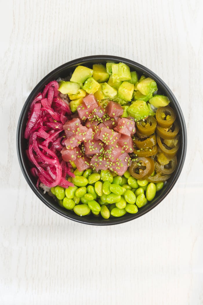 A vibrant poke bowl with fresh tuna, edamame, pickled onions, and more.